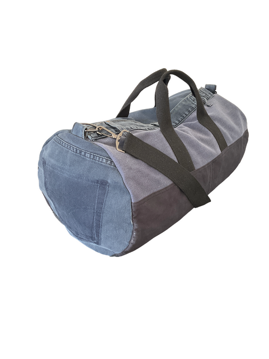 Duffel bag with denim exterior on a white background
